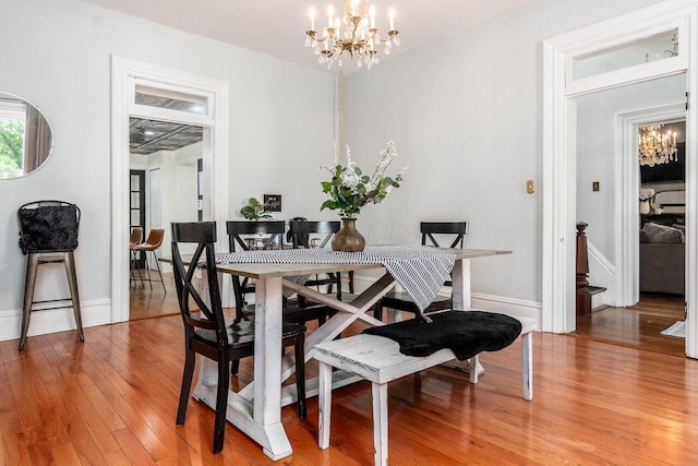 369 E Main St, Circleville, OH 43113 - dining room featuring a chandelier, light wood-type flooring, and baseboards