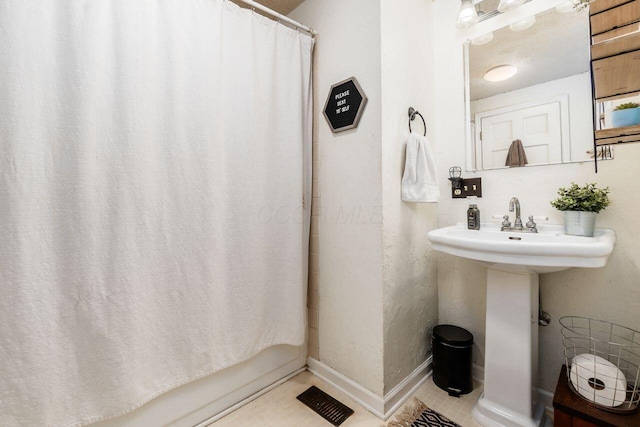 369 E Main St, Circleville, OH 43113 - bathroom featuring shower / bath combo and a sink
