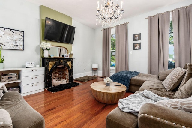 369 E Main St, Circleville, OH 43113 - living area with a fireplace with flush hearth, wood finished floors, a chandelier, and baseboards