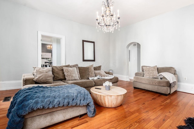 369 E Main St, Circleville, OH 43113 - living area with arched walkways, a chandelier, and wood finished floors