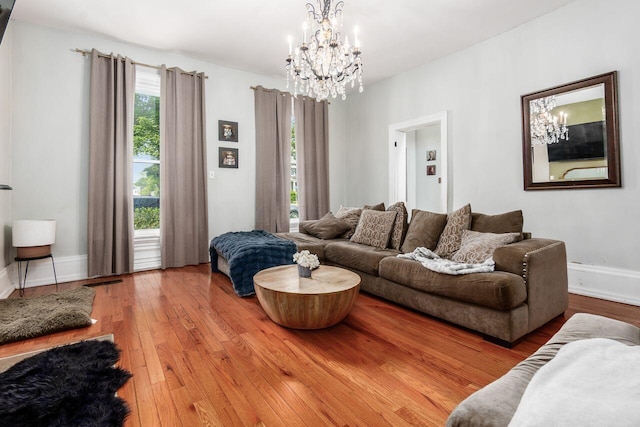 369 E Main St, Circleville, OH 43113 - living area with a chandelier, wood-type flooring, and baseboards