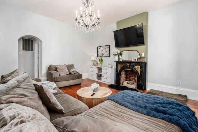 369 E Main St, Circleville, OH 43113 - living room featuring arched walkways, wood finished floors, baseboards, and a chandelier