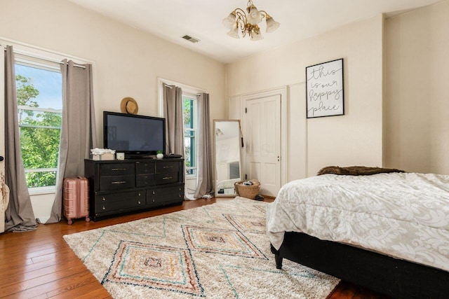 369 E Main St, Circleville, OH 43113 - bedroom featuring a chandelier, multiple windows, and hardwood / wood-style floors