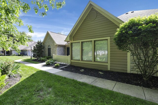 53 Stone House Ct, Newark, OH 43055 - view of front of property with stone siding, a front lawn, and roof with shingles