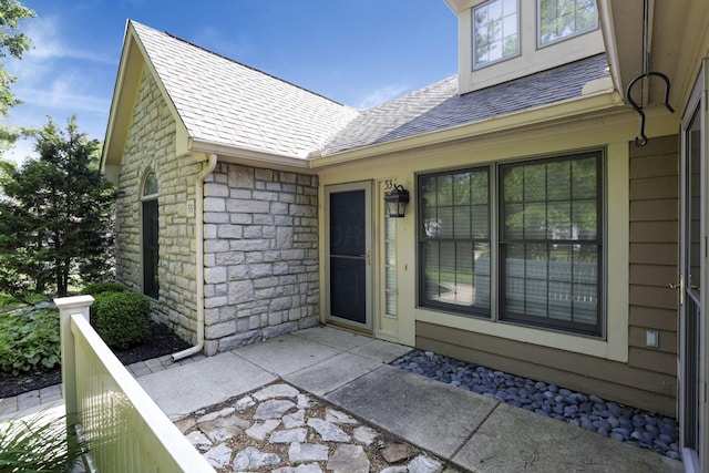 53 Stone House Ct, Newark, OH 43055 - view of exterior entry with a shingled roof and stone siding