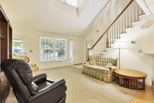 53 Stone House Ct, Newark, OH 43055 - living area featuring stairway, baseboards, high vaulted ceiling, and wood finished floors