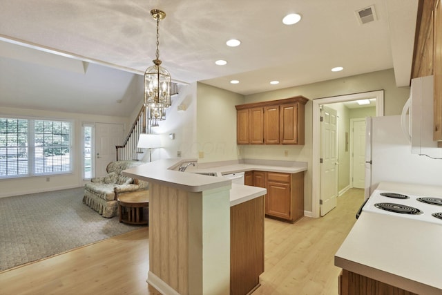 53 Stone House Ct, Newark, OH 43055 - kitchen with a peninsula, light countertops, hanging light fixtures, light wood finished floors, and recessed lighting