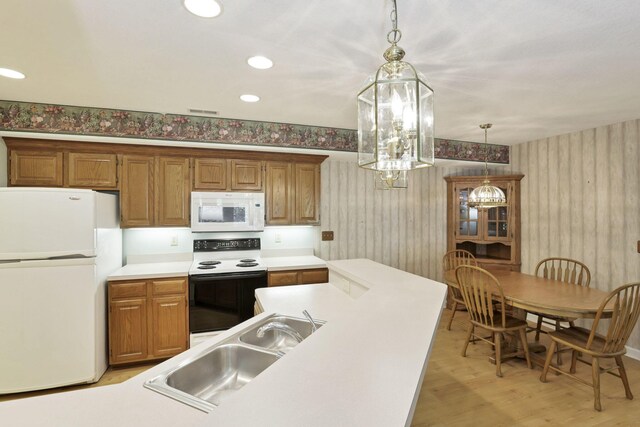 53 Stone House Ct, Newark, OH 43055 - kitchen featuring white appliances, wallpapered walls, hanging light fixtures, a sink, and light wood finished floors