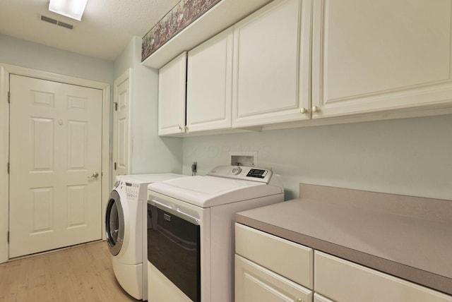 53 Stone House Ct, Newark, OH 43055 - washroom featuring cabinet space, separate washer and dryer, and light wood-type flooring