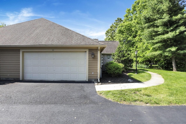 53 Stone House Ct, Newark, OH 43055 - view of home's exterior featuring a shingled roof, a yard, a garage, and driveway