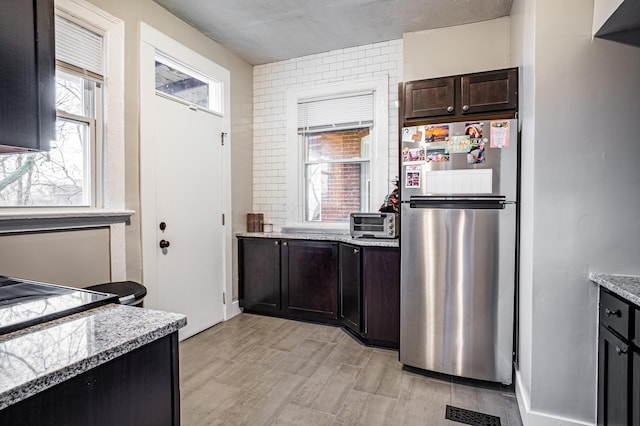 382 Carpenter St, Columbus, OH 43205 - kitchen with freestanding refrigerator and dark brown cabinetry