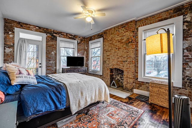 382 Carpenter St, Columbus, OH 43205 - bedroom with brick wall, hardwood / wood-style floors, and a ceiling fan