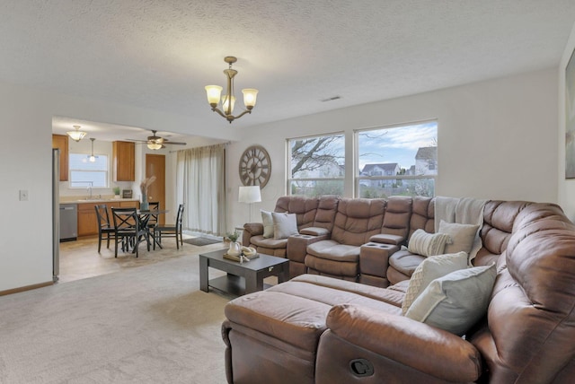 1993 Schrive Dr, Hilliard, OH 43026 - living room with a chandelier, light carpet, a ceiling fan, baseboards, and a textured ceiling