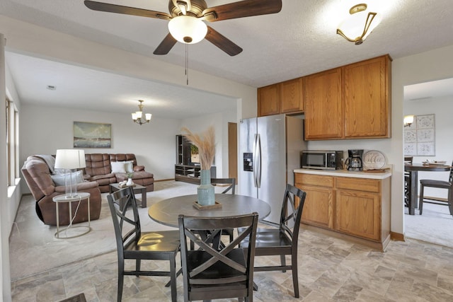 1993 Schrive Dr, Hilliard, OH 43026 - dining space with ceiling fan, light stone finish floors, and a chandelier
