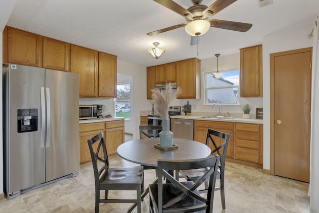 1993 Schrive Dr, Hilliard, OH 43026 - kitchen with stainless steel appliances, a sink, light countertops, and ceiling fan