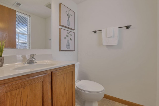 1993 Schrive Dr, Hilliard, OH 43026 - half bathroom featuring vanity, toilet, tile patterned floors, and baseboards