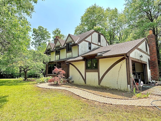 5401 Plantation Rd, Sunbury, OH 43074 - view of property exterior featuring a chimney, a yard, stucco siding, and a garage