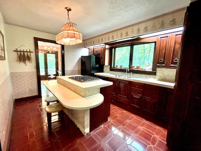 5401 Plantation Rd, Sunbury, OH 43074 - kitchen with freestanding refrigerator, wainscoting, light countertops, healthy amount of natural light, and a textured ceiling