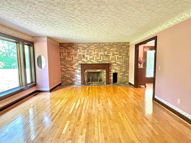 5401 Plantation Rd, Sunbury, OH 43074 - unfurnished living room featuring plenty of natural light, wood-type flooring, baseboards, and a textured ceiling