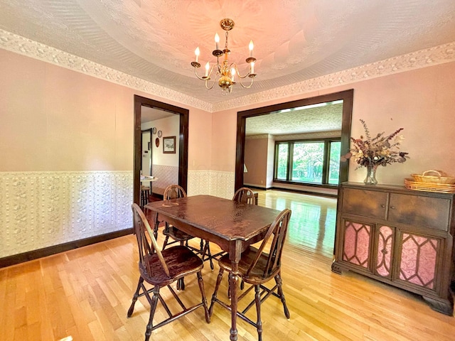 5401 Plantation Rd, Sunbury, OH 43074 - dining room with a wainscoted wall, light wood-style floors, and a chandelier