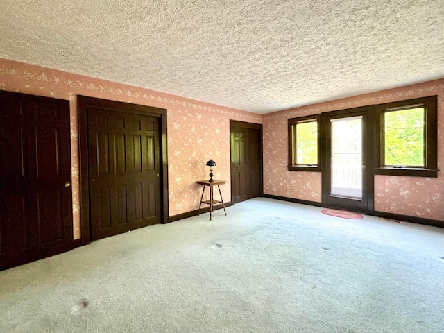 5401 Plantation Rd, Sunbury, OH 43074 - spare room with a textured ceiling, wallpapered walls, carpet, and baseboards