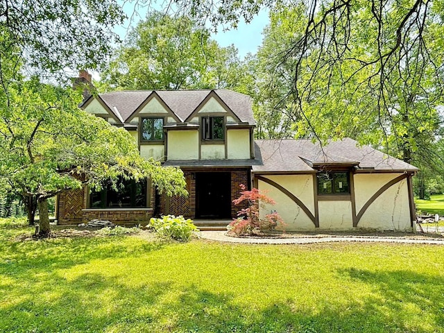 5401 Plantation Rd, Sunbury, OH 43074 - tudor home with stucco siding, a front yard, and a chimney