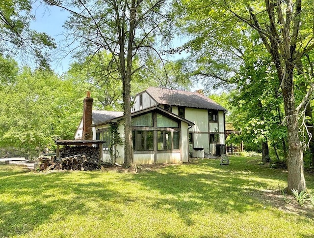 5401 Plantation Rd, Sunbury, OH 43074 - back of property with a chimney, a yard, and central air condition unit