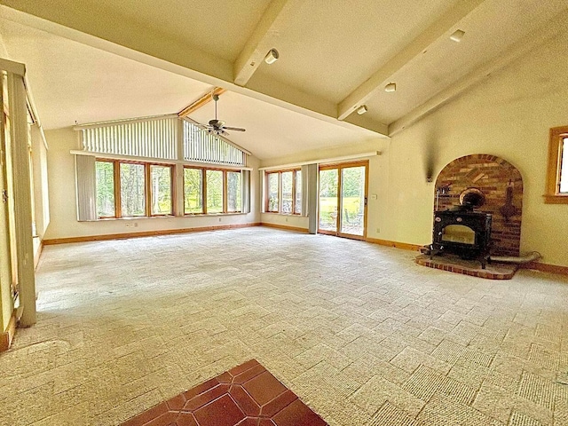 5401 Plantation Rd, Sunbury, OH 43074 - unfurnished living room featuring carpet flooring, baseboards, ceiling fan, a wood stove, and beamed ceiling