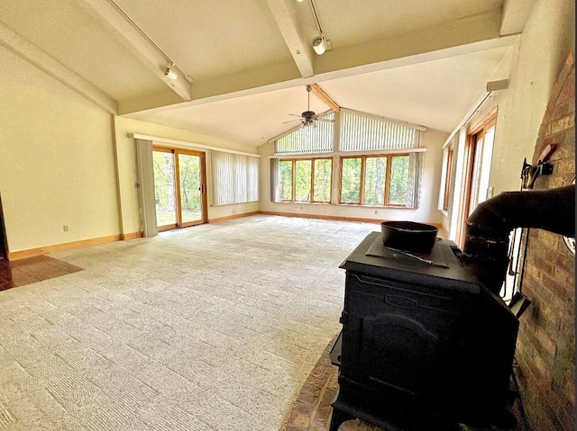 5401 Plantation Rd, Sunbury, OH 43074 - living room featuring rail lighting, a wood stove, carpet floors, and baseboards