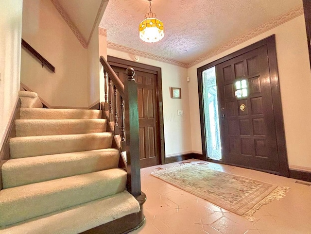 5401 Plantation Rd, Sunbury, OH 43074 - entrance foyer with a textured ceiling, stairway, baseboards, and crown molding