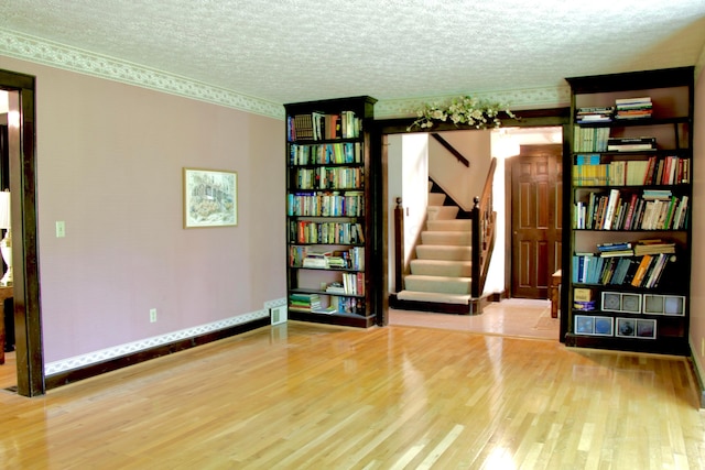 5401 Plantation Rd, Sunbury, OH 43074 - empty room with wood finished floors, stairway, a textured ceiling, and baseboards