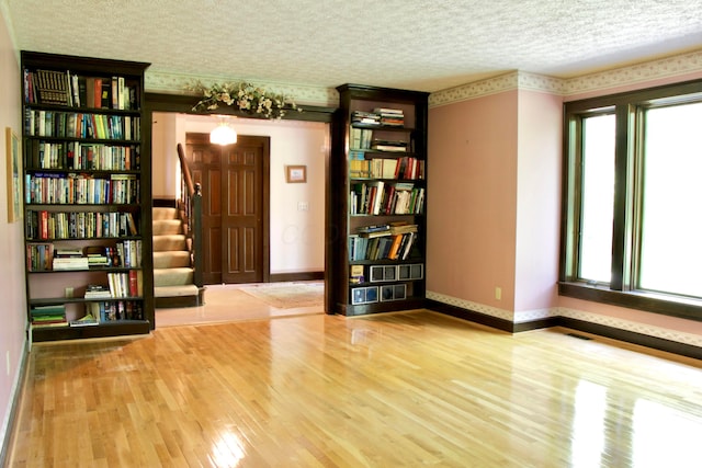 5401 Plantation Rd, Sunbury, OH 43074 - unfurnished room featuring stairway, wood finished floors, baseboards, and a textured ceiling