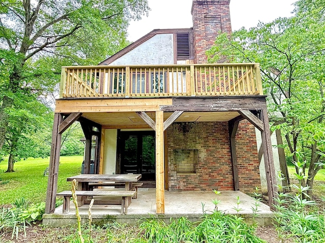 5401 Plantation Rd, Sunbury, OH 43074 - rear view of property featuring a patio, a deck, a chimney, and brick siding