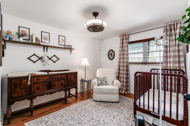 410 Acton Rd, Columbus, OH 43214 - bedroom with wood finished floors and a nursery area