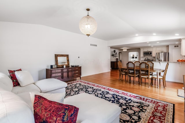 410 Acton Rd, Columbus, OH 43214 - living area with vaulted ceiling, light wood-style flooring, and recessed lighting