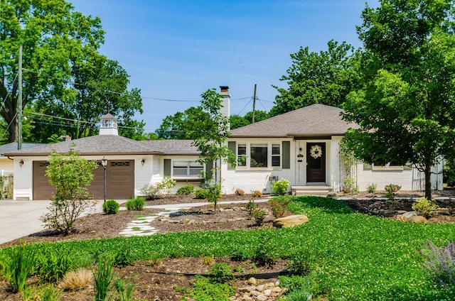 410 Acton Rd, Columbus, OH 43214 - single story home with a garage, driveway, a chimney, a front yard, and a shingled roof