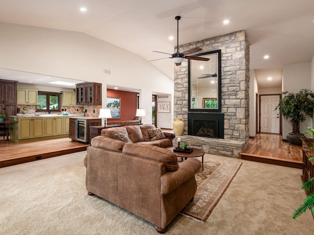 5769 Royal Lytham Ct, Dublin, OH 43017 - living area featuring vaulted ceiling, a ceiling fan, light colored carpet, a fireplace, and recessed lighting