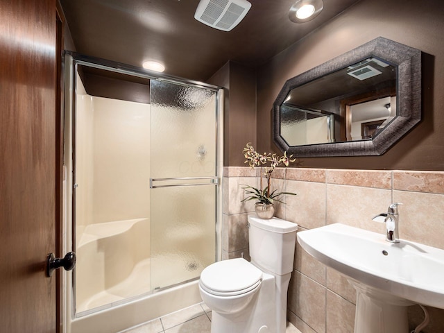 5769 Royal Lytham Ct, Dublin, OH 43017 - full bathroom with toilet, a shower stall, tile patterned flooring, tile walls, and a wainscoted wall