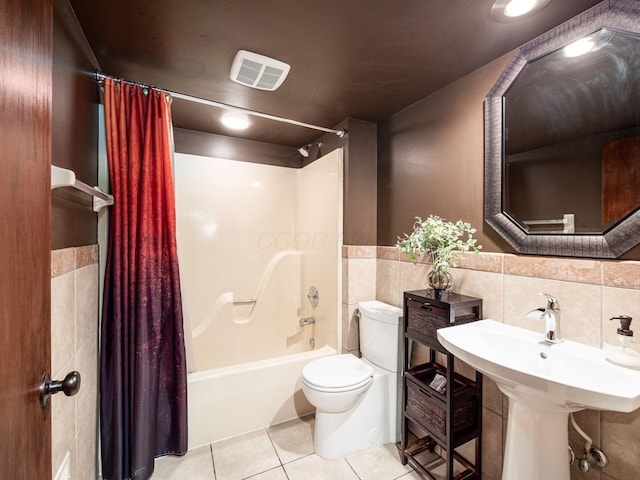 5769 Royal Lytham Ct, Dublin, OH 43017 - bathroom with shower / bath combo, toilet, tile patterned flooring, tile walls, and wainscoting