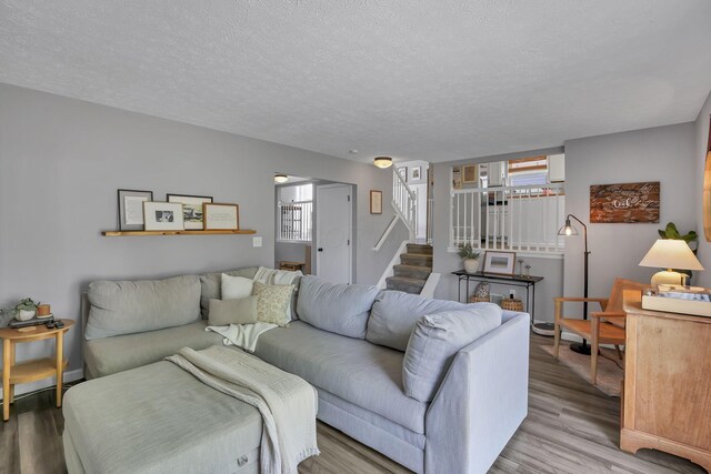 840 Gulliver Dr, Columbus, OH 43207 - living area with wood finished floors, stairway, and a textured ceiling