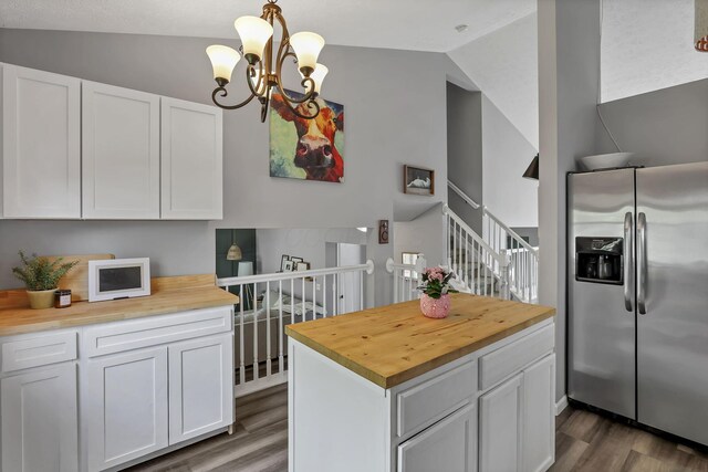 840 Gulliver Dr, Columbus, OH 43207 - kitchen with stainless steel fridge, wood counters, lofted ceiling, wood finished floors, and a chandelier