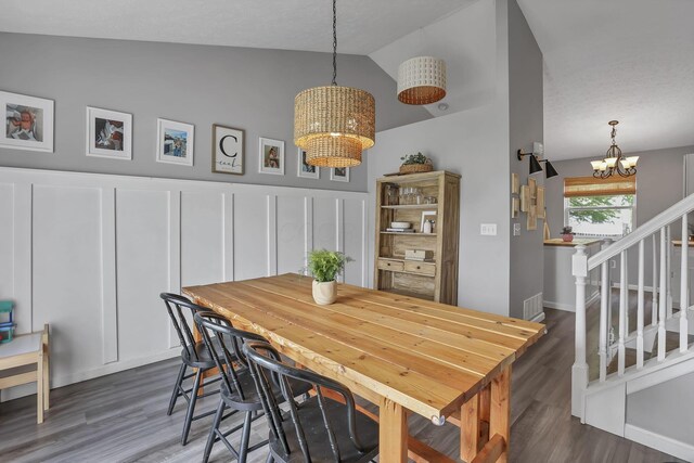 840 Gulliver Dr, Columbus, OH 43207 - dining area with a chandelier, vaulted ceiling, stairway, and dark wood finished floors
