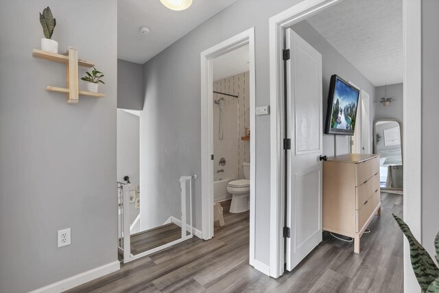 840 Gulliver Dr, Columbus, OH 43207 - corridor with an upstairs landing, wood finished floors, baseboards, and a textured ceiling