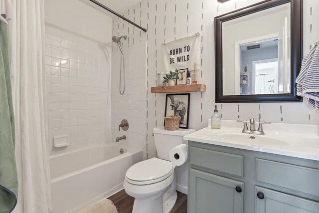 840 Gulliver Dr, Columbus, OH 43207 - bathroom featuring shower / bathtub combination with curtain, vanity, toilet, and wood finished floors