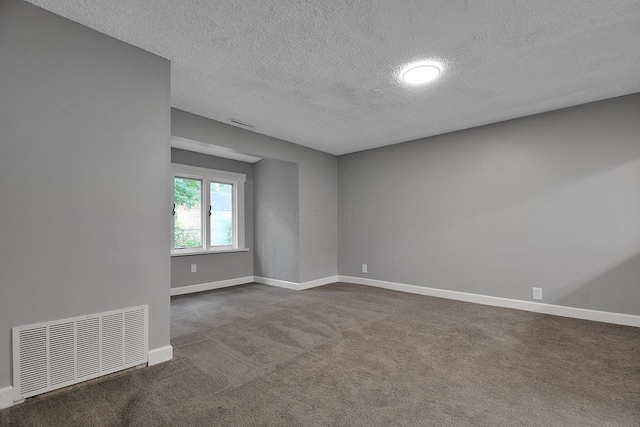 2732 Baughman Ave, Columbus, OH 43211 - spare room featuring a textured ceiling and dark colored carpet