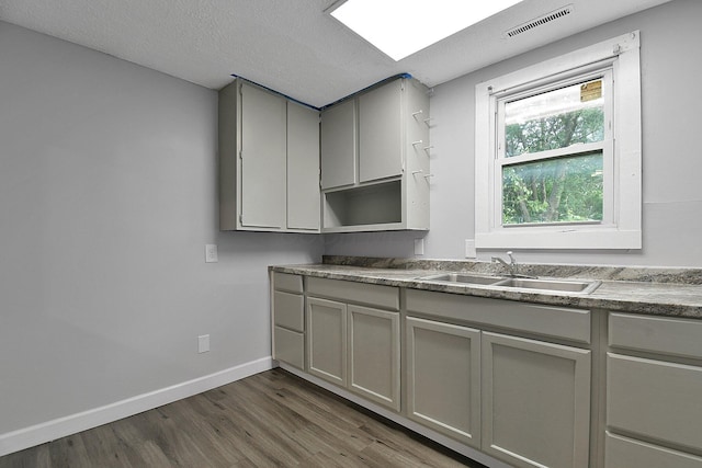 2732 Baughman Ave, Columbus, OH 43211 - kitchen featuring gray cabinets, dark wood-style floors, and a textured ceiling