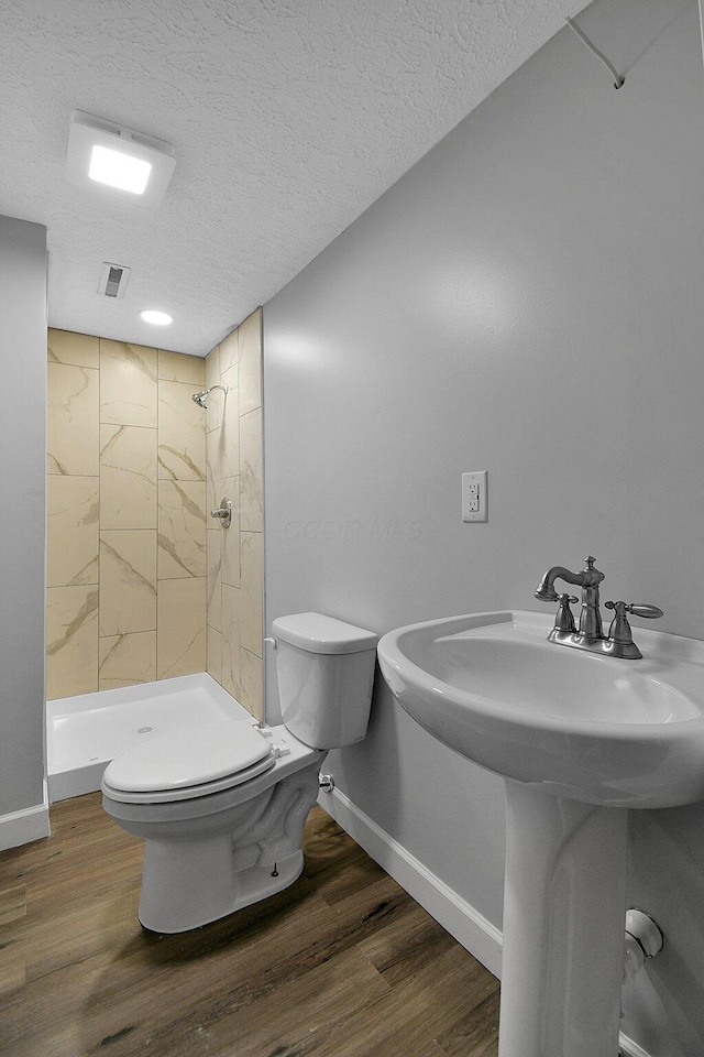 2732 Baughman Ave, Columbus, OH 43211 - bathroom with a textured ceiling, a shower stall, and wood finished floors