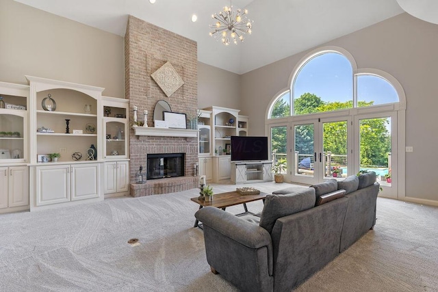 2570 Jewett Rd, Powell, OH 43065 - living area featuring high vaulted ceiling, light carpet, a brick fireplace, and a chandelier