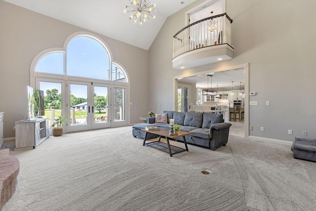 2570 Jewett Rd, Powell, OH 43065 - living room featuring a chandelier, high vaulted ceiling, carpet flooring, and french doors