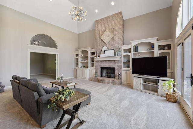 2570 Jewett Rd, Powell, OH 43065 - living room featuring high vaulted ceiling, light colored carpet, a chandelier, healthy amount of natural light, and a brick fireplace
